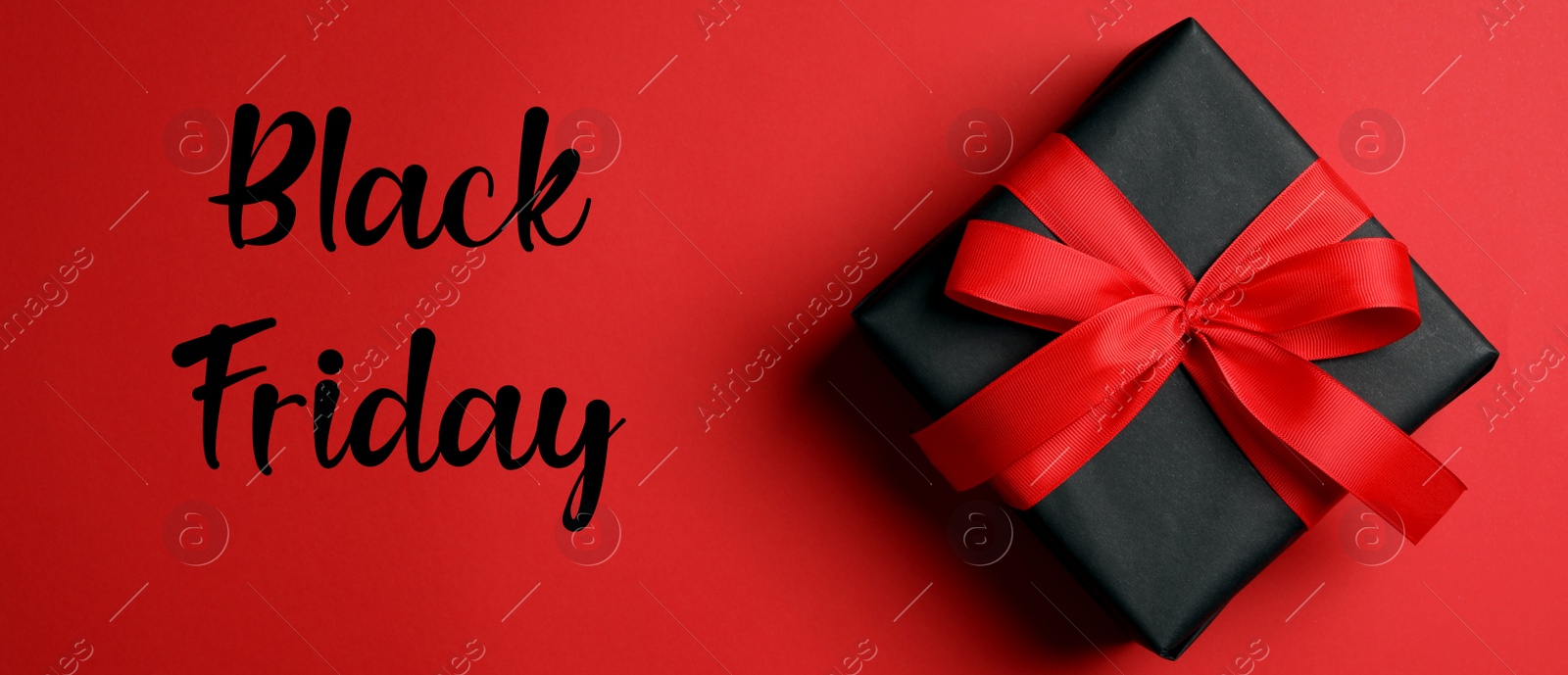 Image of Phrase Black Friday and gift box on red background, top view. Banner design