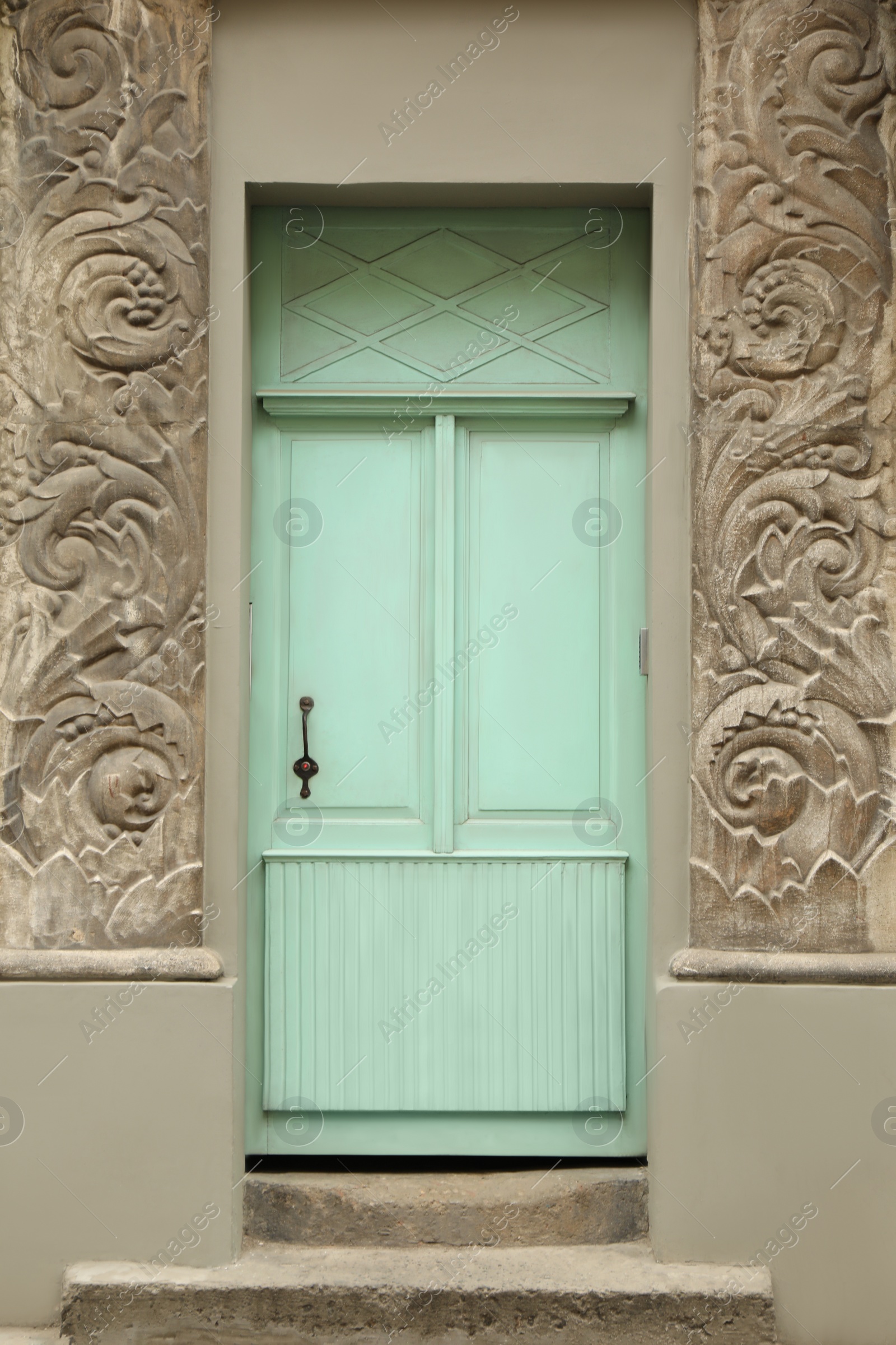 Photo of View of building with light blue wooden door. Exterior design