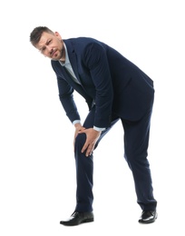 Full length portrait of businessman having knee problems on white background