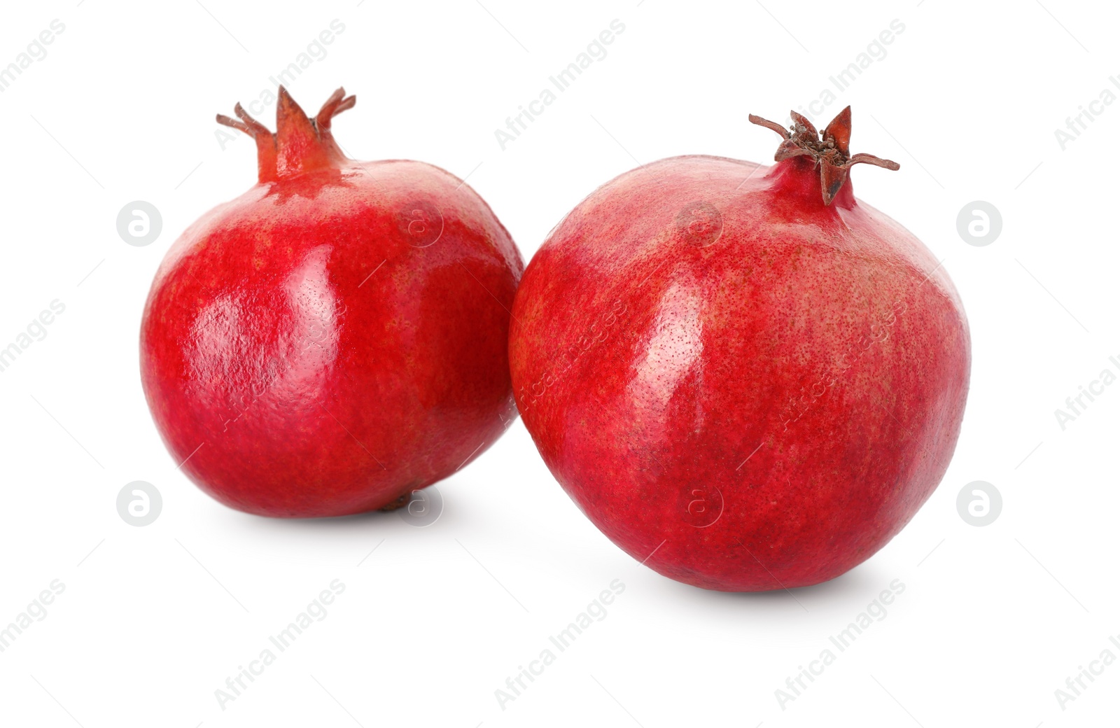 Photo of Two fresh ripe pomegranates isolated on white