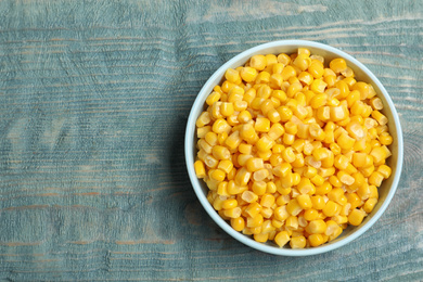 Tasty canned sweet corn on blue wooden table, top view