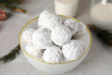 Photo of Christmas snowball cookies in bowl on light table