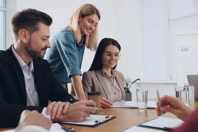 Photo of Businesswoman having meeting with her employees in office