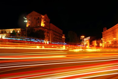 Road traffic, motion blur effect. View of night cityscape with car light trails