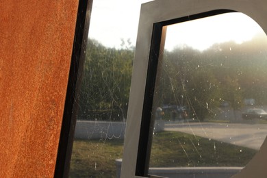 Photo of Cobweb on dusty gates outdoors, closeup view