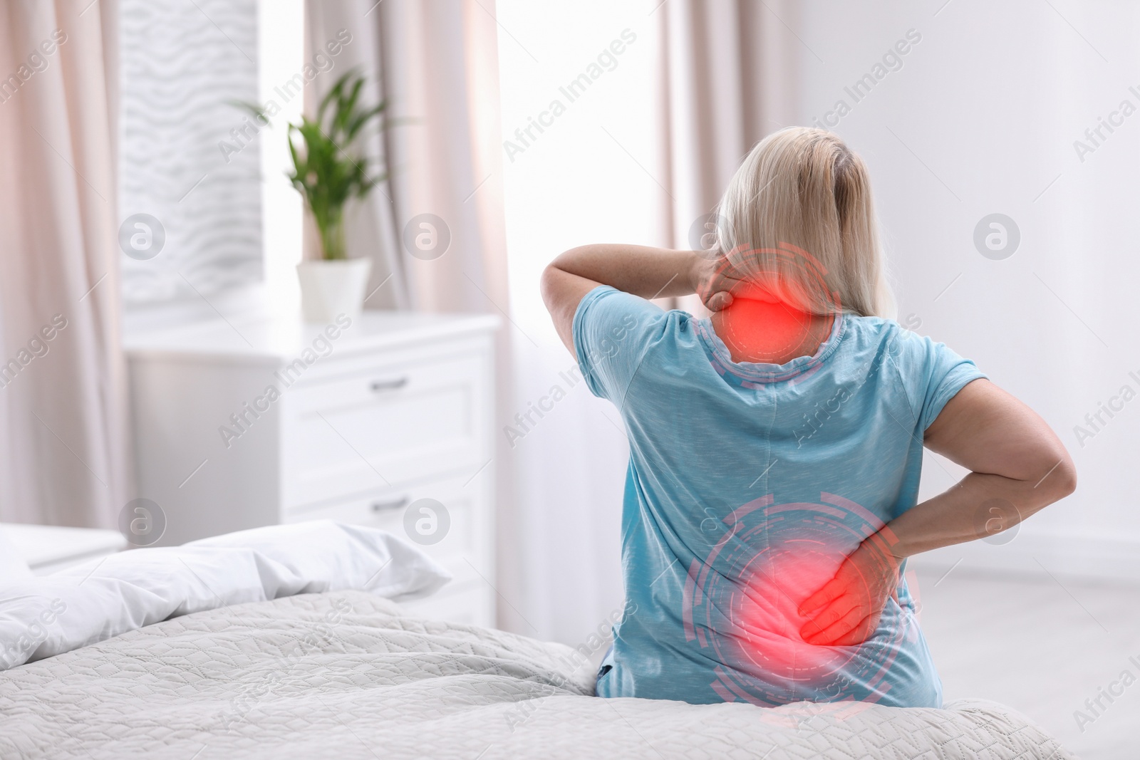 Image of Woman suffering from back pain after sleeping on uncomfortable mattress at home