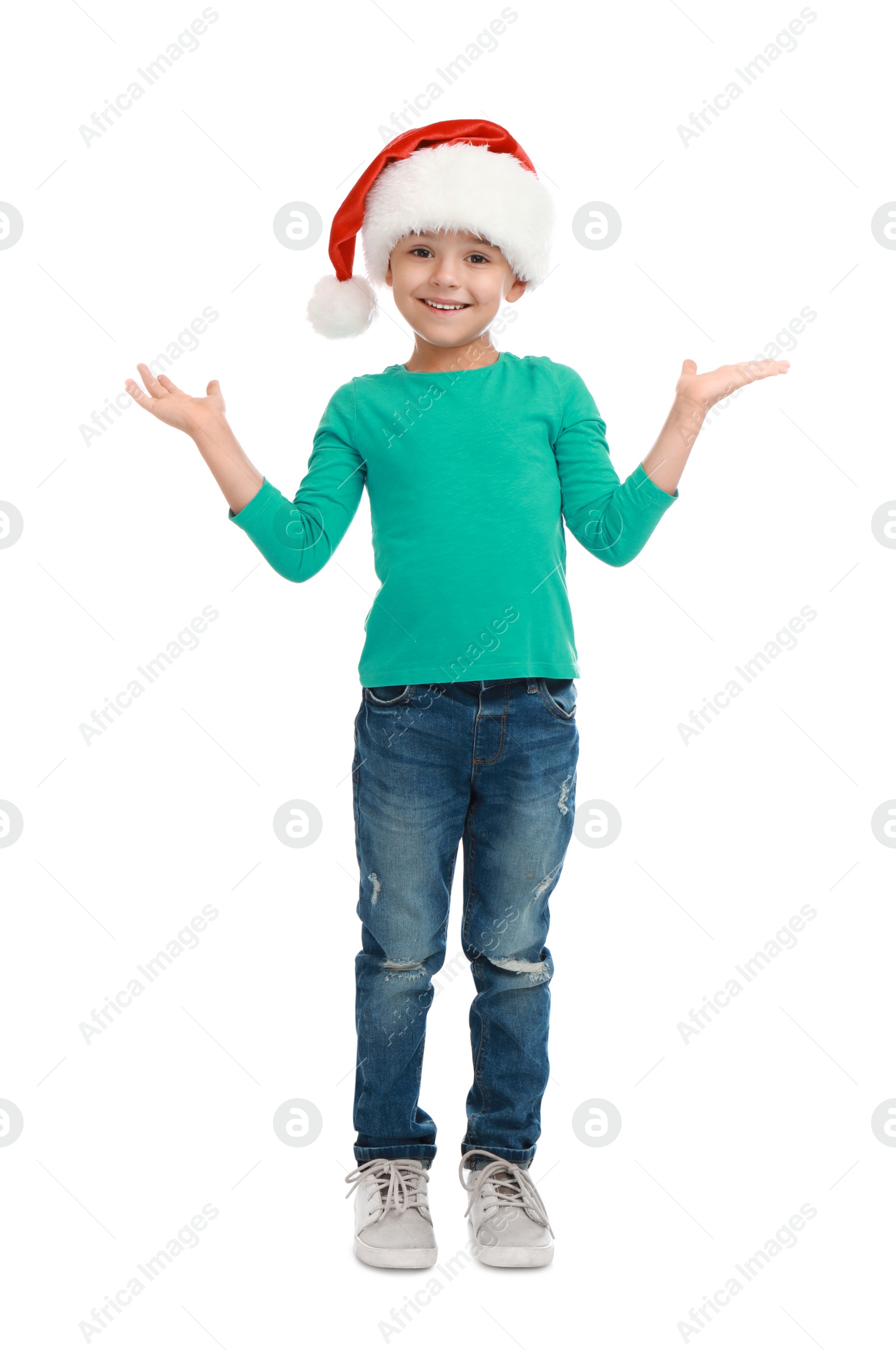 Photo of Cute little child wearing Santa hat on white background. Christmas holiday