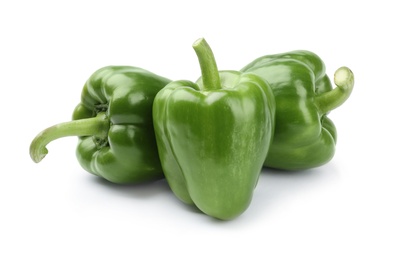 Ripe green bell peppers on white background