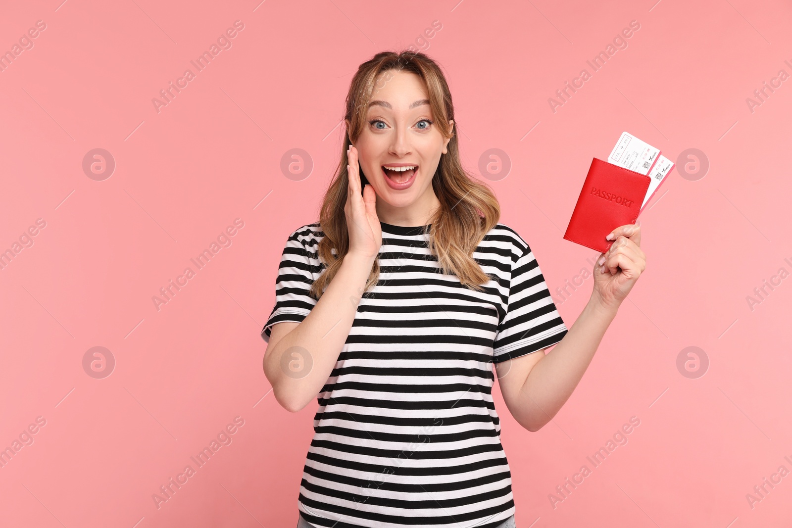 Photo of Happy young woman with passport and ticket on pink background