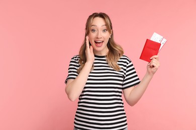 Photo of Happy young woman with passport and ticket on pink background