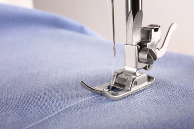Photo of Closeup view of sewing machine with fabric