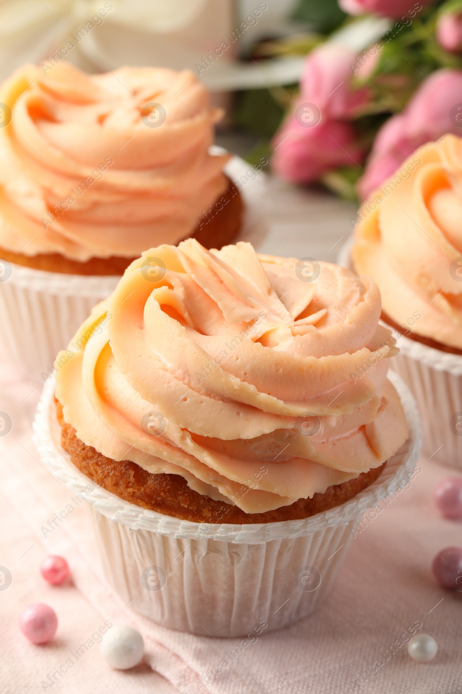 Photo of Tasty cupcake with cream on table, closeup view