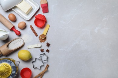 Cooking utensils and ingredients on light marble table, flat lay. Space for text