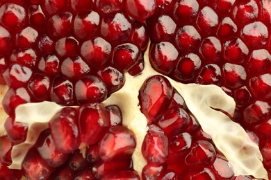 Photo of Ripe juicy pomegranate grains as background, closeup