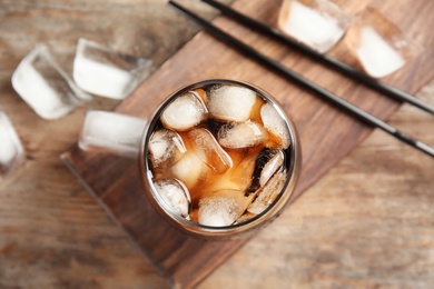 Composition with glass of refreshing cola on table, top view