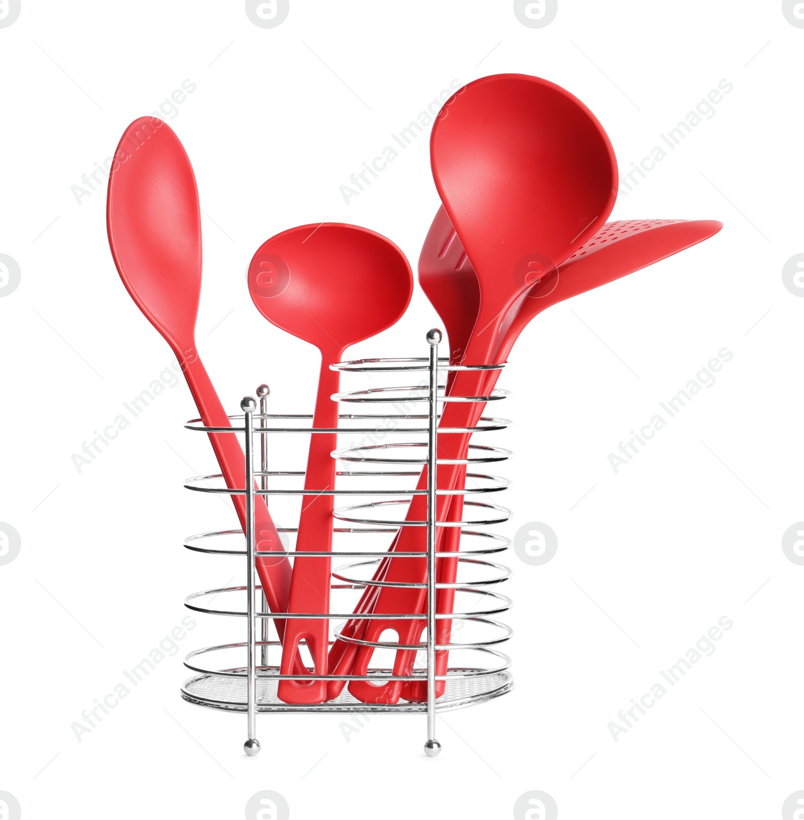 Photo of Set of red cooking utensils in holder isolated on white