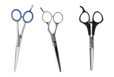 Image of Set of different professional hairdresser scissors on white background 