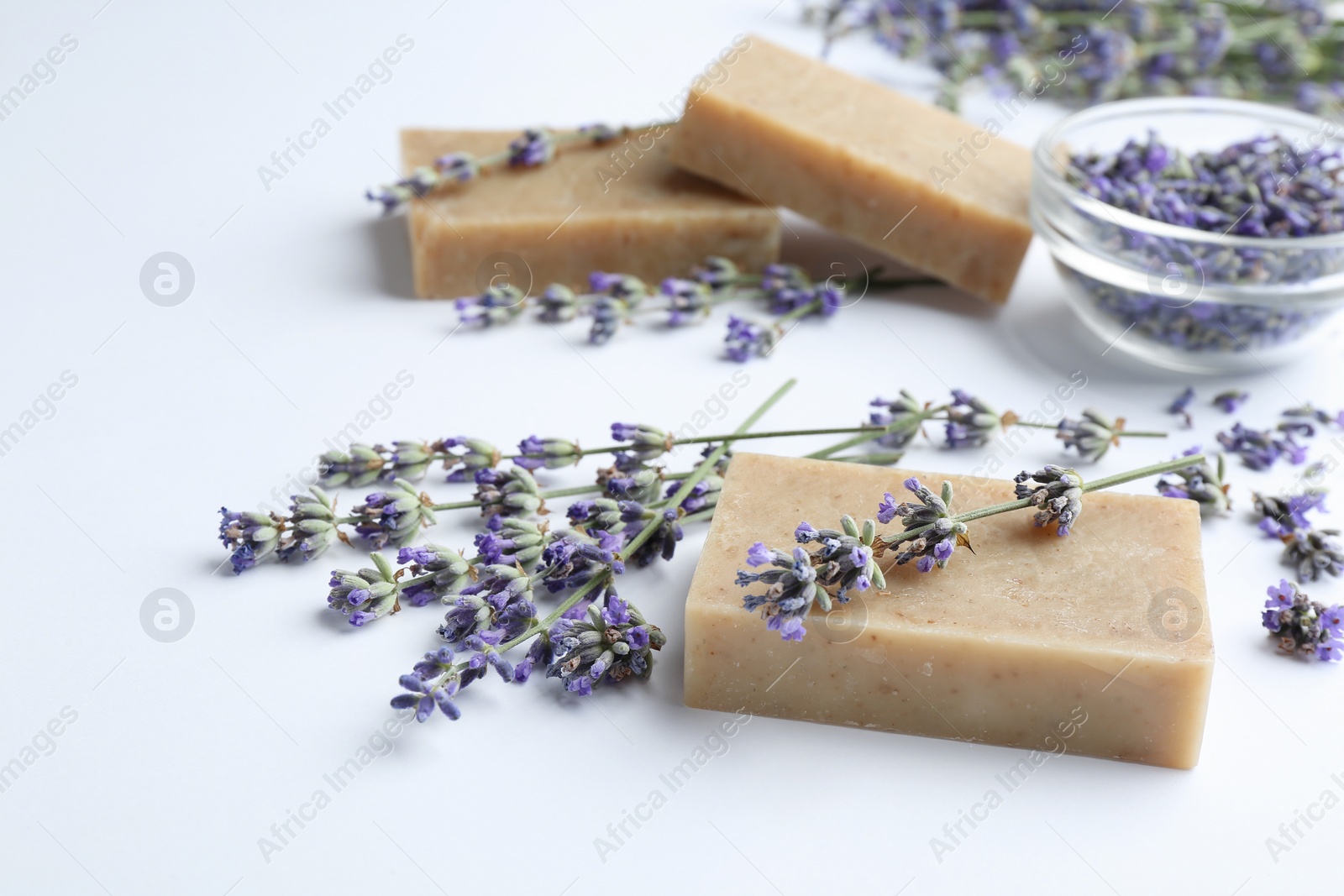 Photo of Hand made soap bars with lavender flowers on white background