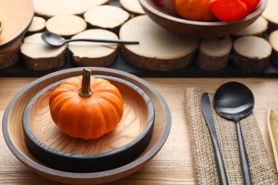 Autumn table setting with pumpkin on wooden background