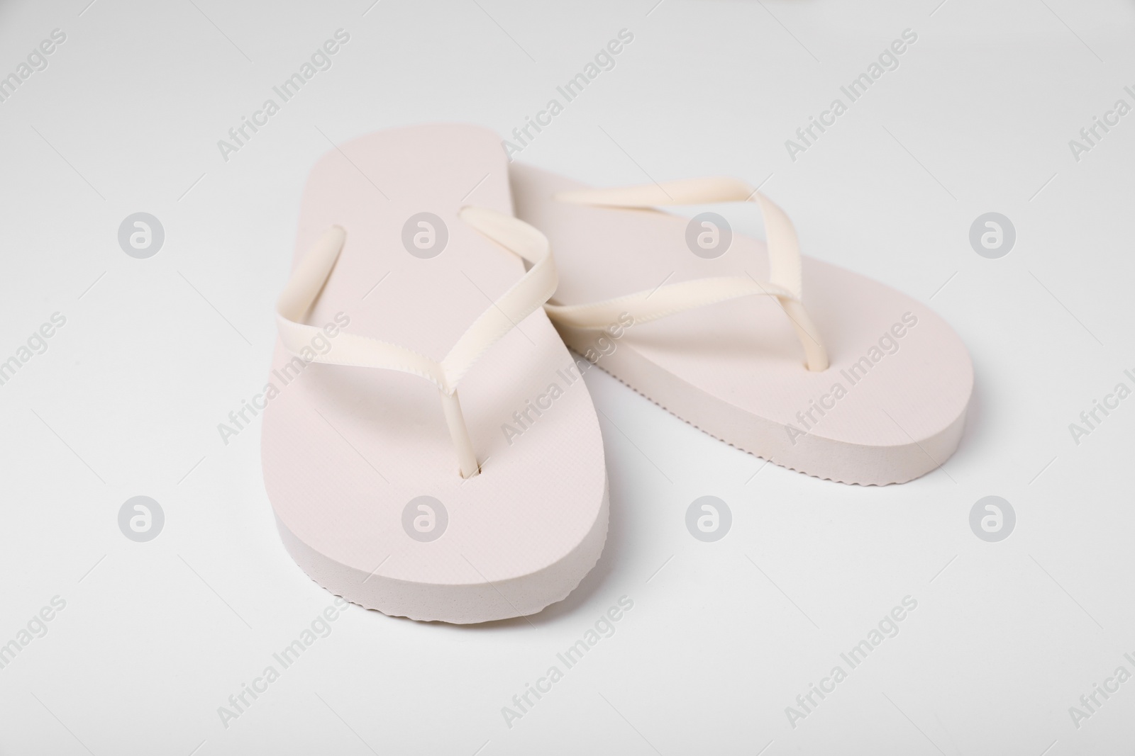 Photo of Pair of stylish flip flops on white background