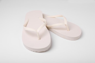 Photo of Pair of stylish flip flops on white background