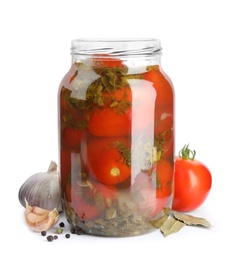 Pickled tomatoes in glass jar and products on white background