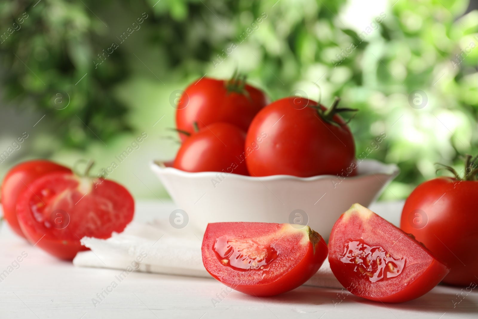 Photo of Fresh ripe tomatoes on white wooden table