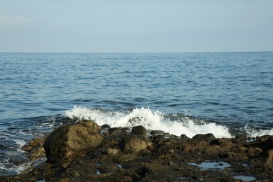 Photo of Picturesque view of sea waves splashing on stones