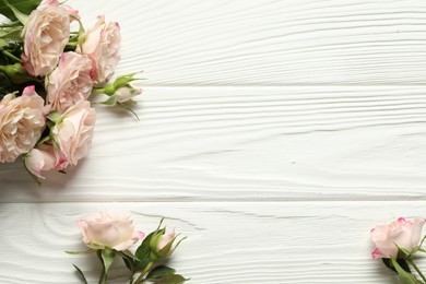 Photo of Happy Mother's Day. Beautiful roses on white wooden table, flat lay. Space for text