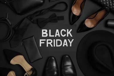 Photo of Flat lay composition with stylish accessories and phrase Black Friday on dark background