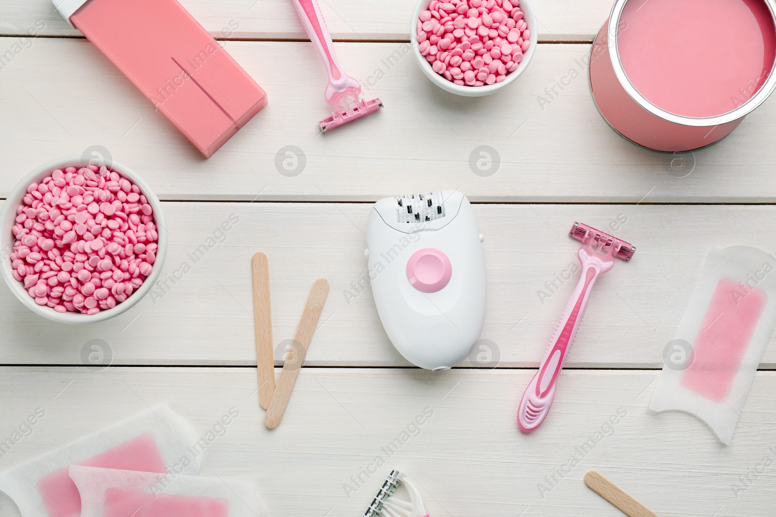 Photo of Set of epilation products on white wooden table, flat lay