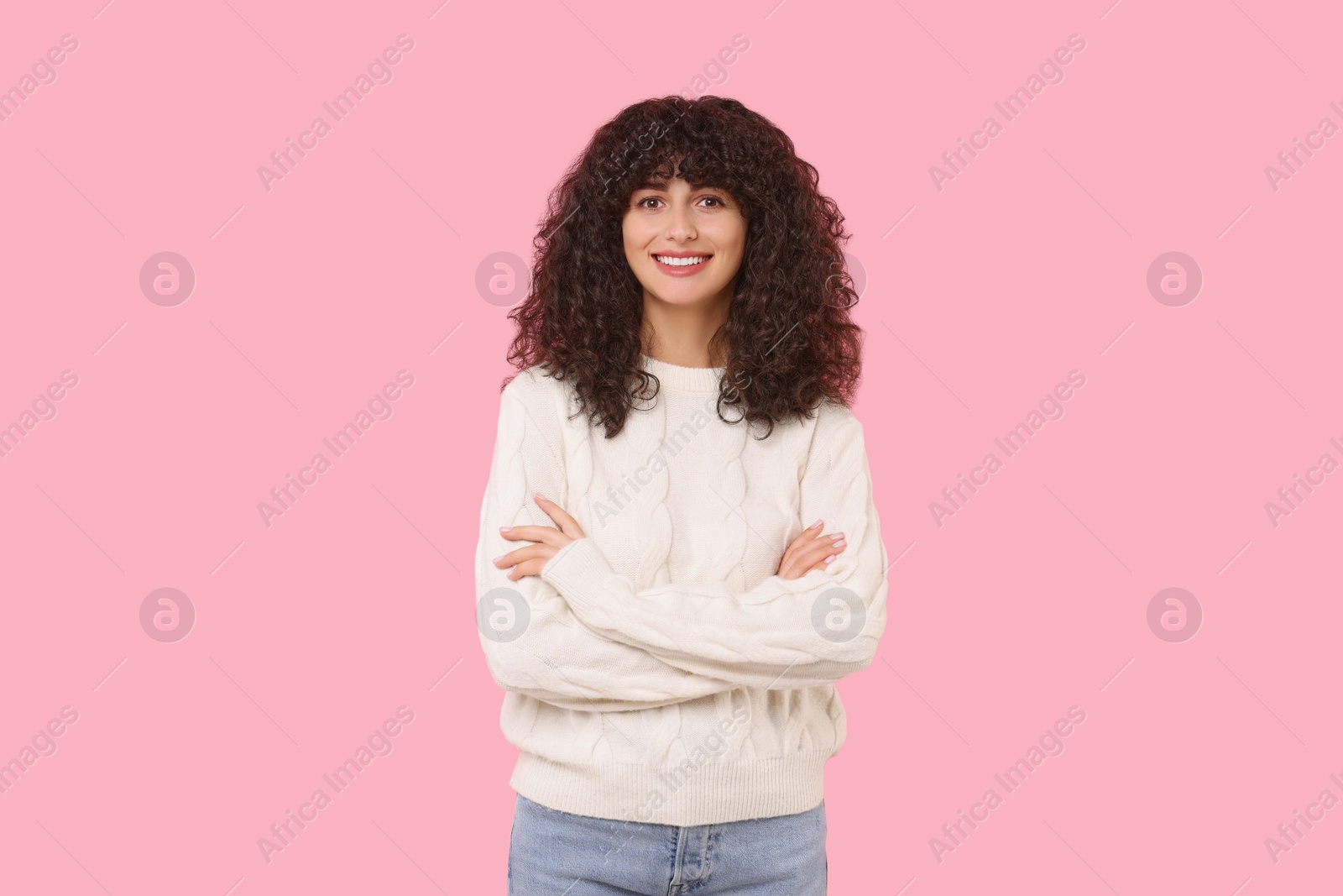 Photo of Happy young woman in stylish white sweater on pink background