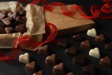 Beautiful heart shaped chocolate candies on black table