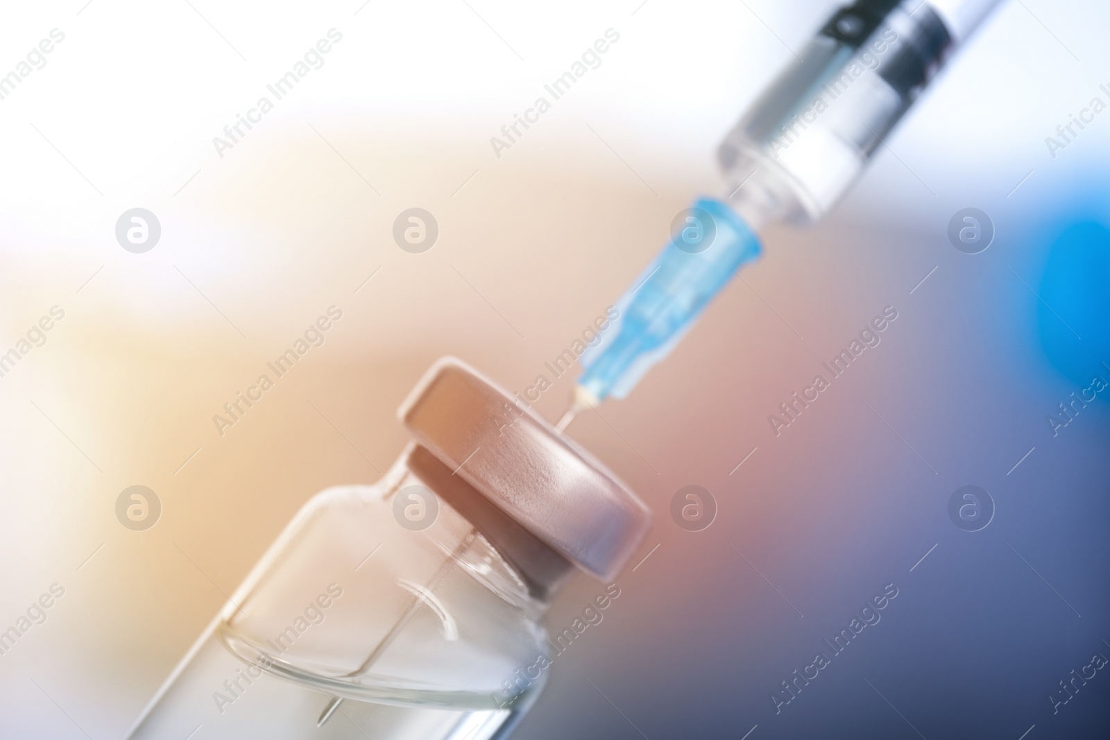 Image of Vial and syringe on blurred background. Vaccination and immunization