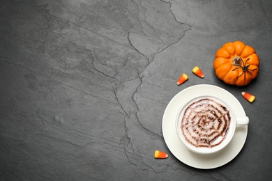 Photo of Flat lay composition of coffee with spider's net latte art on grey table, space for text. Halloween celebration