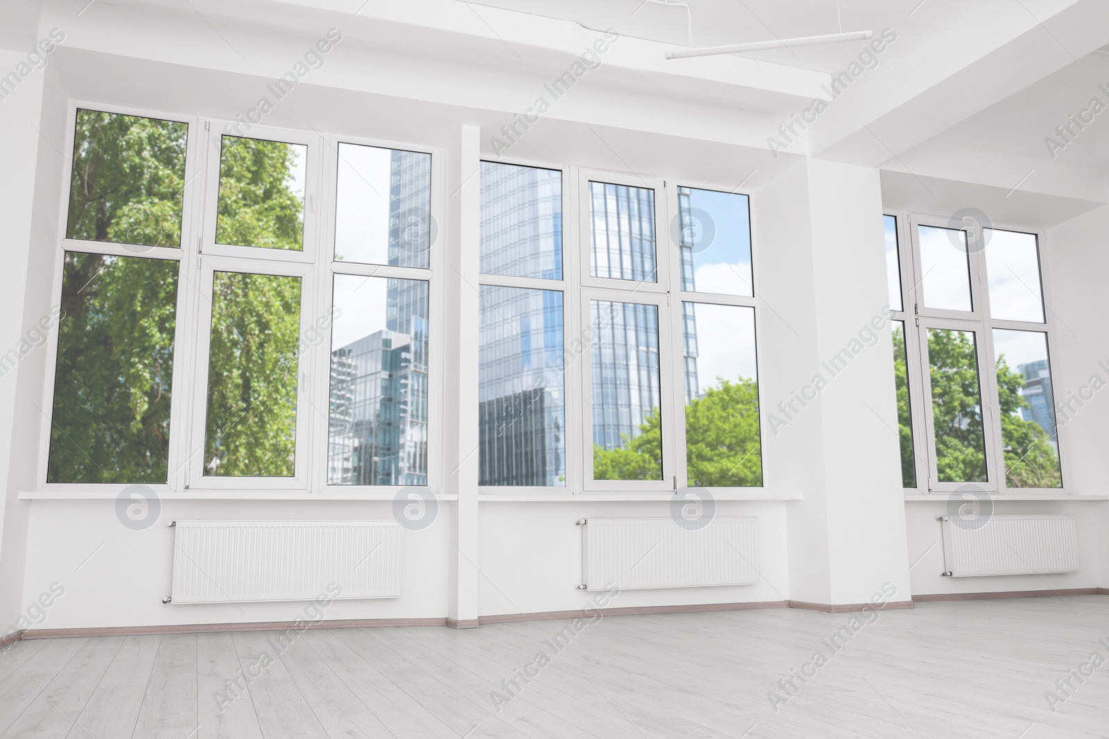 Photo of Modern office room with white walls and windows. Interior design