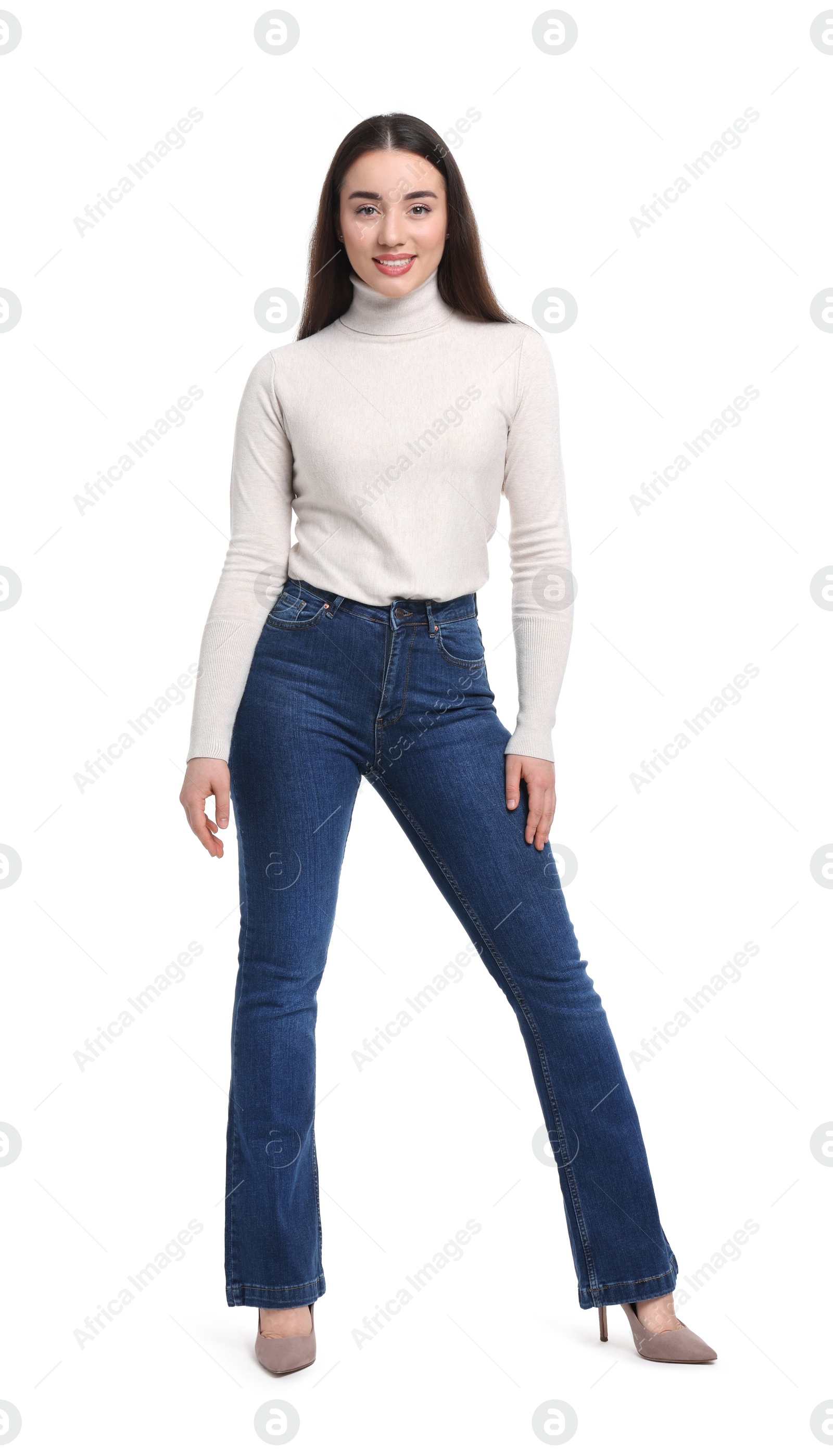 Photo of Young woman in stylish jeans on white background