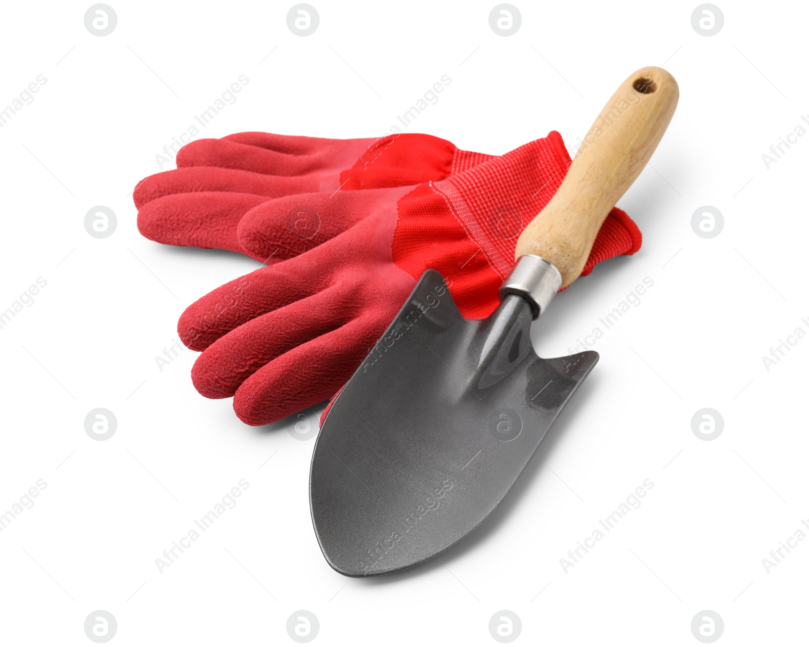 Photo of Gardening gloves and trowel isolated on white