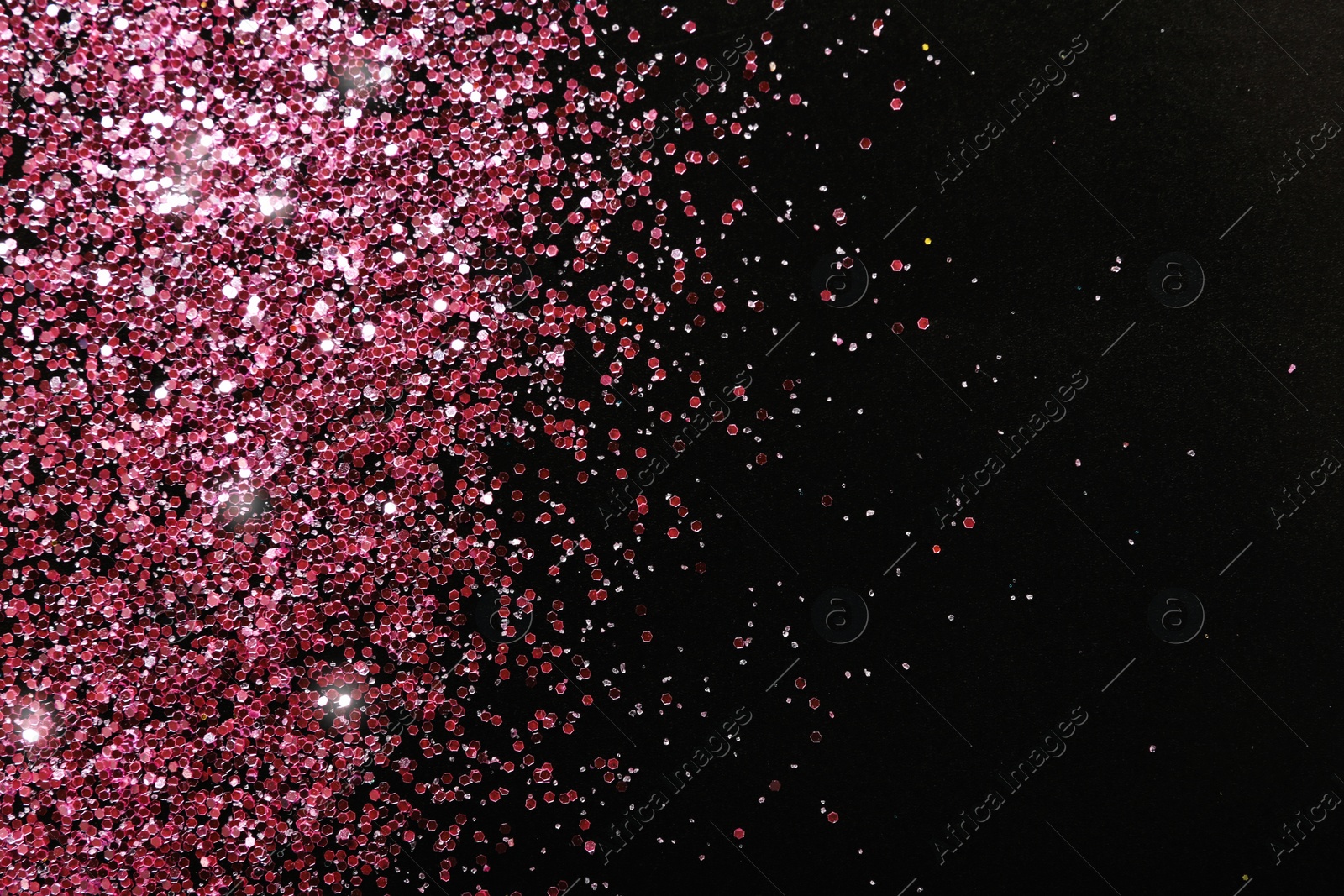Photo of Rose gold glitter on black background, top view with space for text