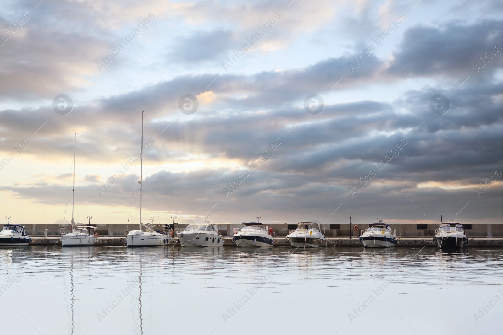 Photo of Beautiful view of city pier with moored boats on sunny day