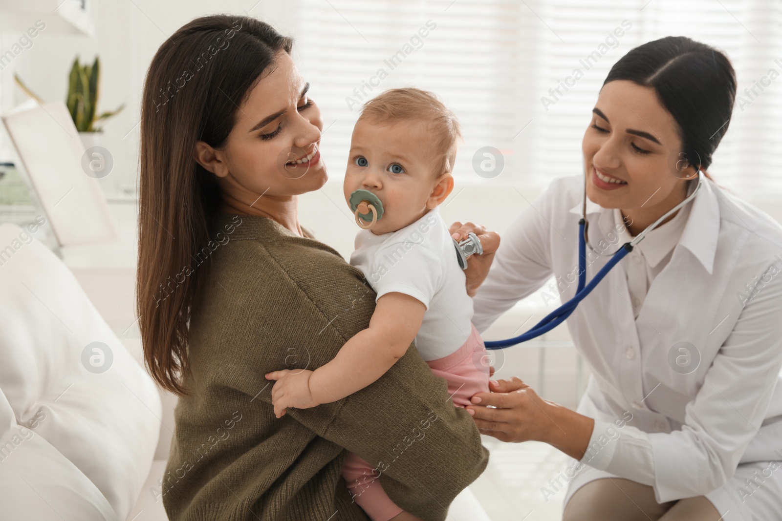 Photo of Mother with her cute baby visiting pediatrician in clinic