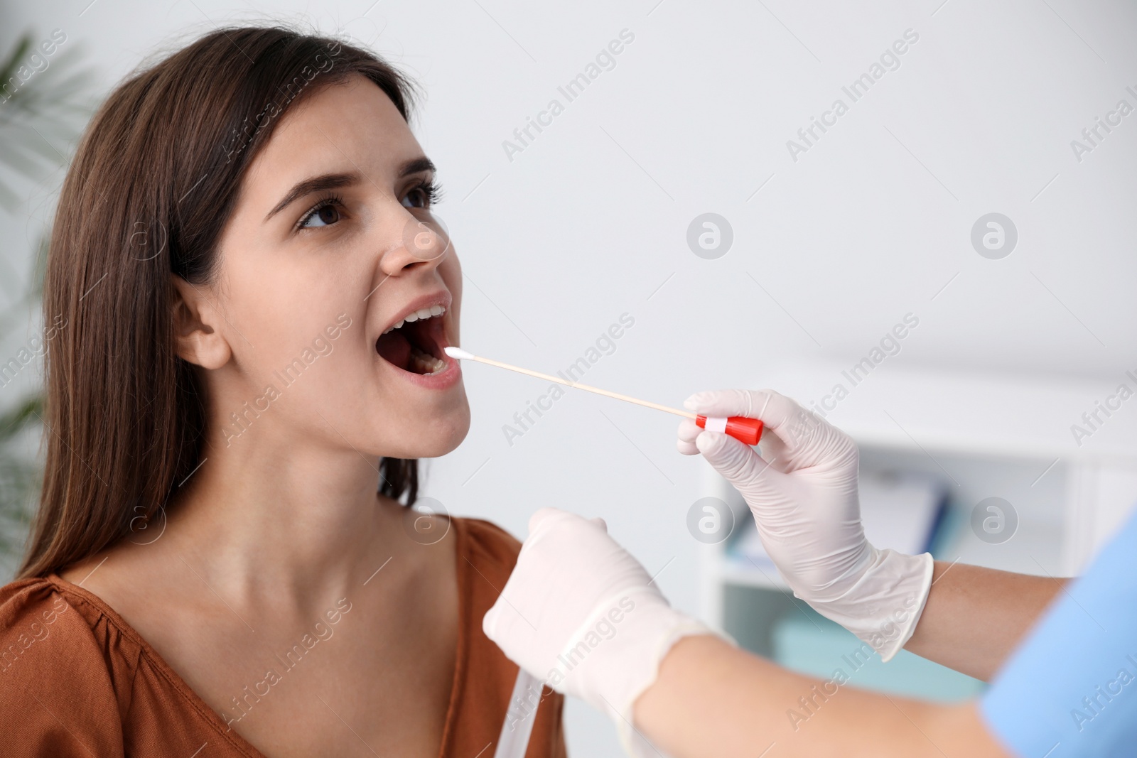 Photo of Doctor taking sample for DNA test from woman in clinic