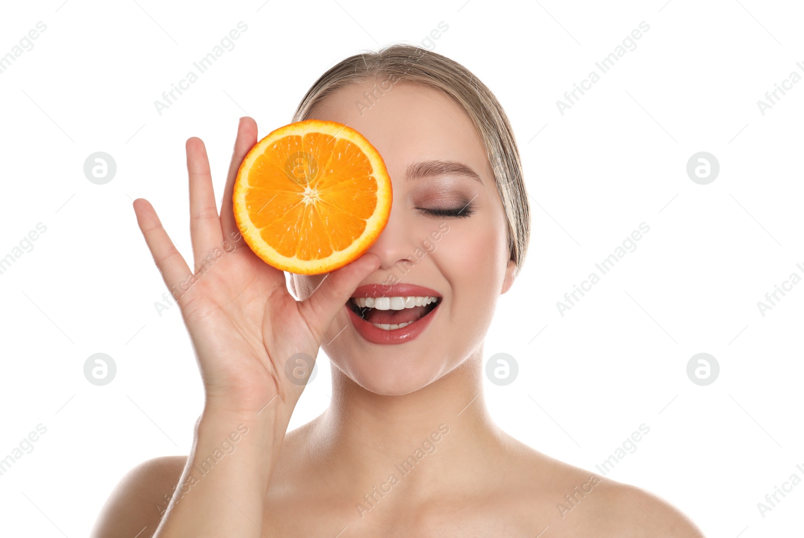 Photo of Young woman with cut orange on white background. Vitamin rich food