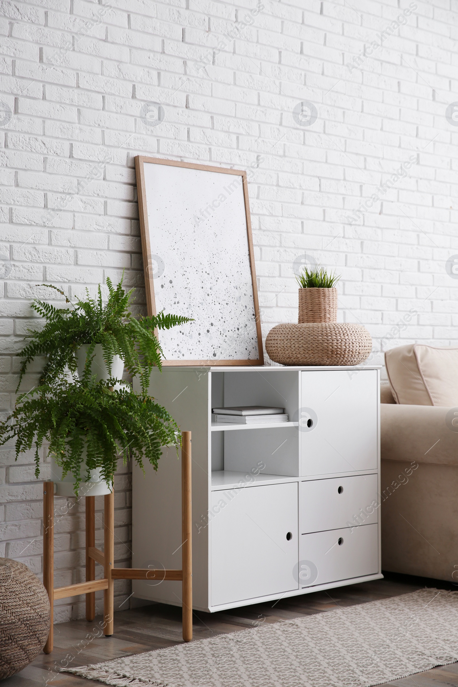 Photo of Modern room interior with stylish white cabinet