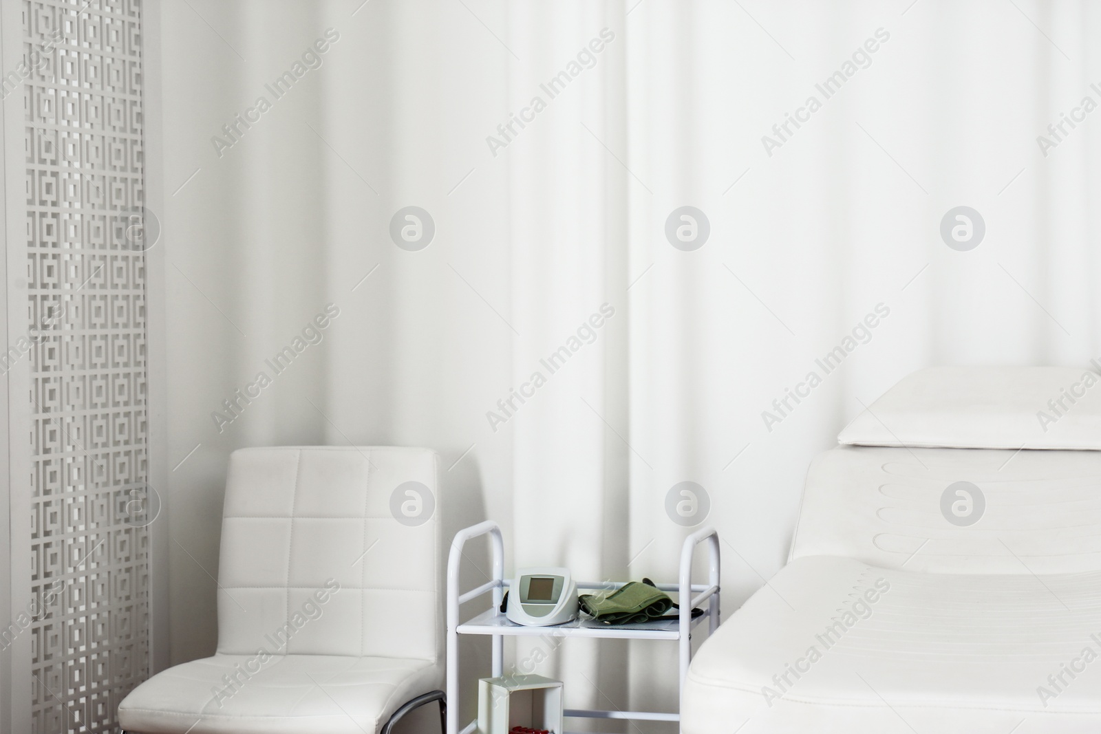 Photo of Empty examination couch in modern medical office