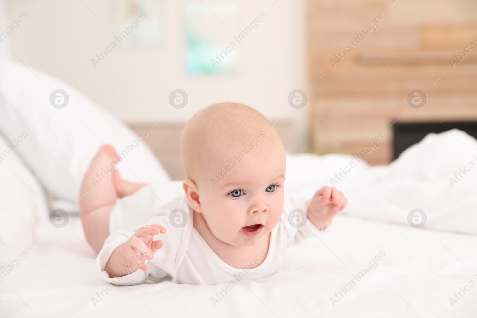 Photo of Cute little baby lying on bed at home