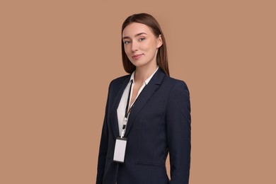 Photo of Woman with blank badge on light brown background