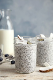Photo of Tasty chia seed pudding with coconut on table