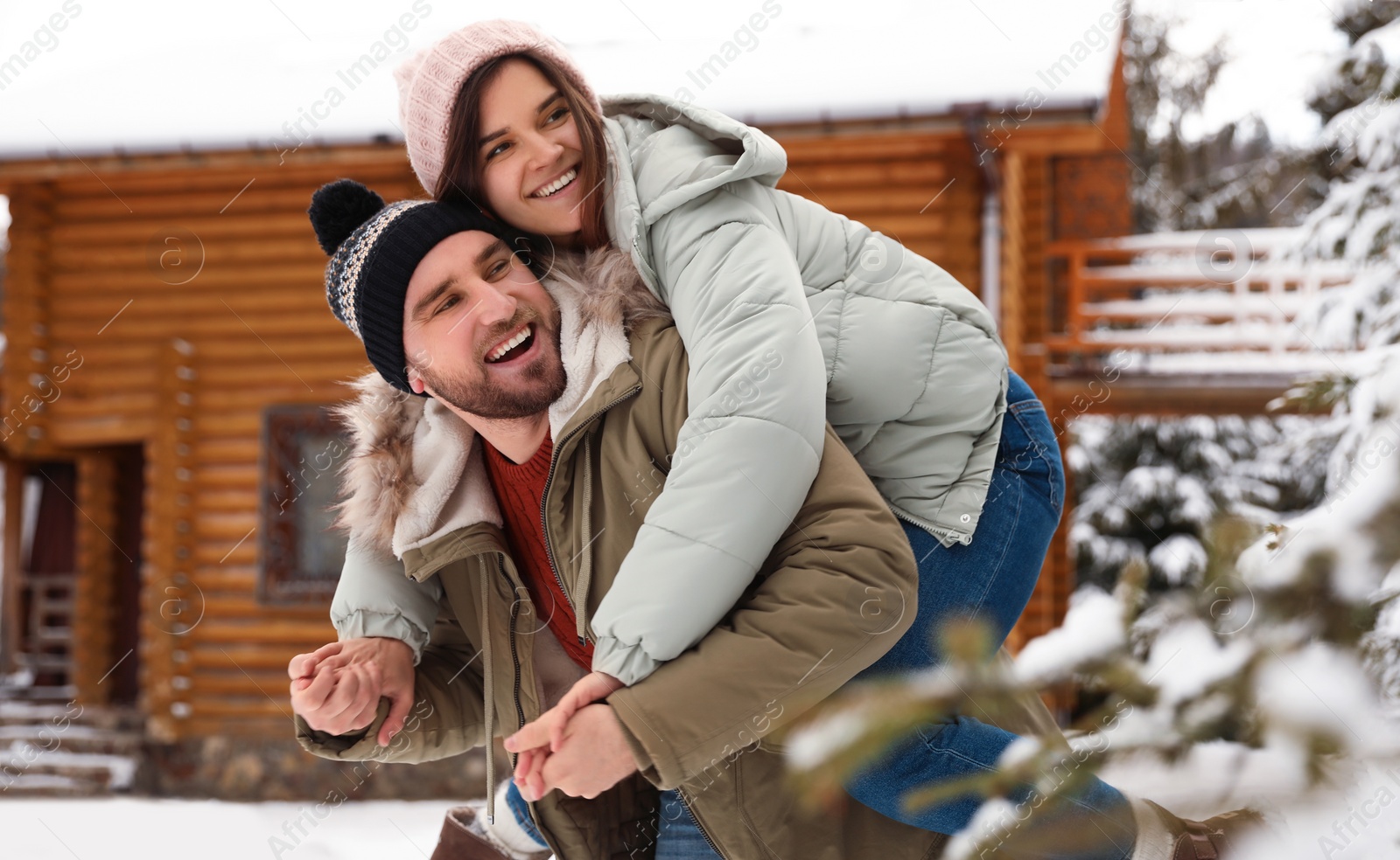 Photo of Lovely couple spending time together on snowy day. Winter vacation