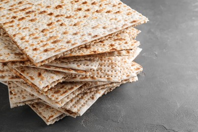 Photo of Stack of matzos on grey table, closeup